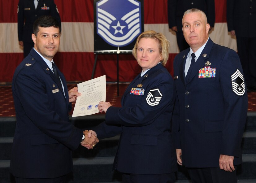 Master Sgt. Jami Linn, 26th Operational Weather Squadron, receives a certificate of promotion from Col. Andrew Gebara, 2nd Bomb Wing commander, and Chief Master Sgt. Beau Markin, 2nd Maintenance Group, during the November Wing Promotion Ceremony on Barksdale Air Force Base, La., Nov. 27, 2013. (U.S. Air Force photo/Senior Airman Joseph A. Pagán Jr.)