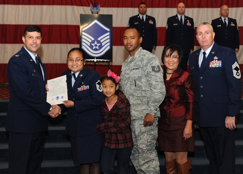 Master Sgt. Regie Alejandro, 2nd Medical Support Squadron, receives a certificate of promotion from Col. Andrew Gebara, 2nd Bomb Wing commander, and Chief Master Sgt. Beau Markin, 2nd Maintenance Group, during the November Wing Promotion Ceremony on Barksdale Air Force Base, La., Nov. 27, 2013. (U.S. Air Force photo/Senior Airman Joseph A. Pagán Jr.)