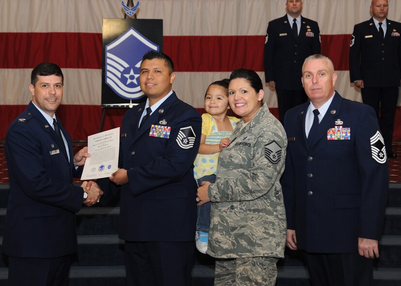 Master Sgt. Roberto Torres Jr., 2nd Logistics Readiness Squadron, receives a certificate of promotion from Col. Andrew Gebara, 2nd Bomb Wing commander, and Chief Master Sgt. Beau Markin, 2nd Maintenance Group, during the November Wing Promotion Ceremony on Barksdale Air Force Base, La., Nov. 27, 2013. (U.S. Air Force photo/Senior Airman Joseph A. Pagán Jr.)