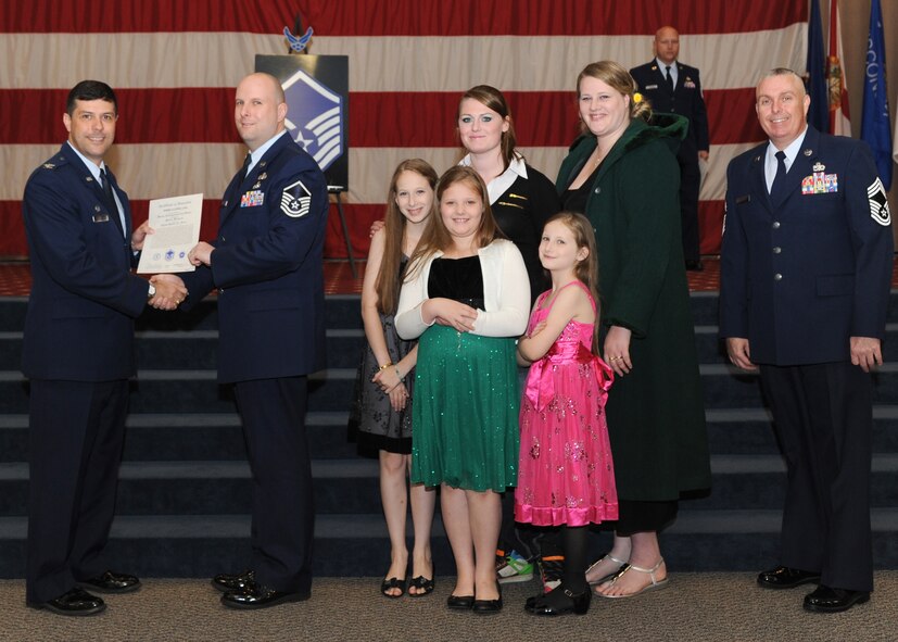 Master Sgt. Joshua Copeland, 2nd Communications Squadron, receives a certificate of promotion from Col. Andrew Gebara, 2nd Bomb Wing commander, and Chief Master Sgt. Beau Markin, 2nd Maintenance Group, during the November Wing Promotion Ceremony on Barksdale Air Force Base, La., Nov. 27, 2013. (U.S. Air Force photo/Senior Airman Joseph A. Pagán Jr.)