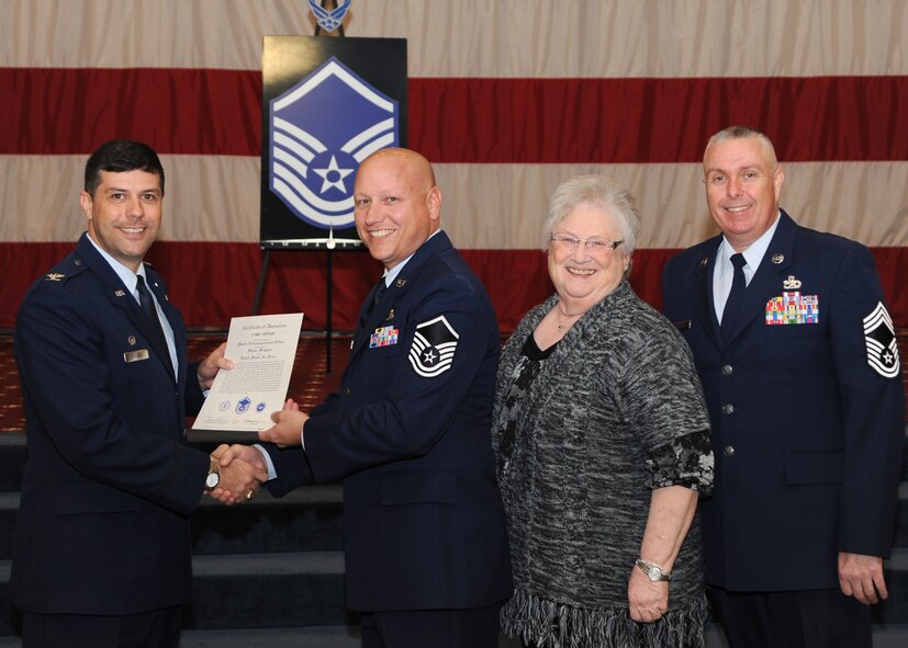Master Sgt. Cory Tipton, 2nd Aircraft Maintenance Squadron, receives a certificate of promotion from Col. Andrew Gebara, 2nd Bomb Wing commander, and Chief Master Sgt. Beau Markin, 2nd Maintenance Group, during the November Wing Promotion Ceremony on Barksdale Air Force Base, La., Nov. 27, 2013. (U.S. Air Force photo/Senior Airman Joseph A. Pagán Jr.)