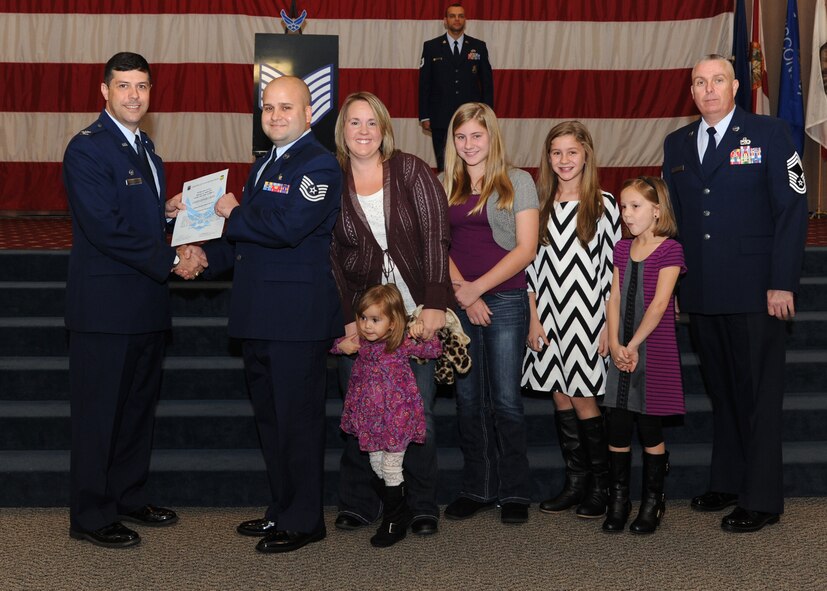 Tech. Sgt. Christopher Casey, 2nd Dental Squadron, receives a certificate of promotion from Col. Andrew Gebara, 2nd Bomb Wing commander, and Chief Master Sgt. Beau Markin, 2nd Maintenance Group, during the November Wing Promotion Ceremony on Barksdale Air Force Base, La., Nov. 27, 2013. (U.S. Air Force photo/Senior Airman Joseph A. Pagán Jr.)
