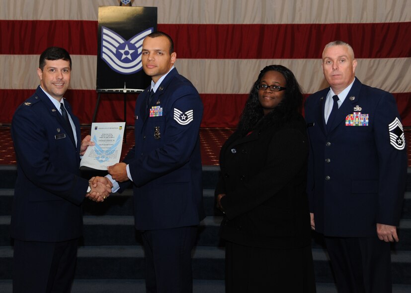 Tech. Sgt. Thomas Linson III, 2nd Civil Engineer Squadron, receives a certificate of promotion from Col. Andrew Gebara, 2nd Bomb Wing commander, and Chief Master Sgt. Beau Markin, 2nd Maintenance Group, during the November Wing Promotion Ceremony on Barksdale Air Force Base, La., Nov. 27, 2013. (U.S. Air Force photo/Senior Airman Joseph A. Pagán Jr.)
