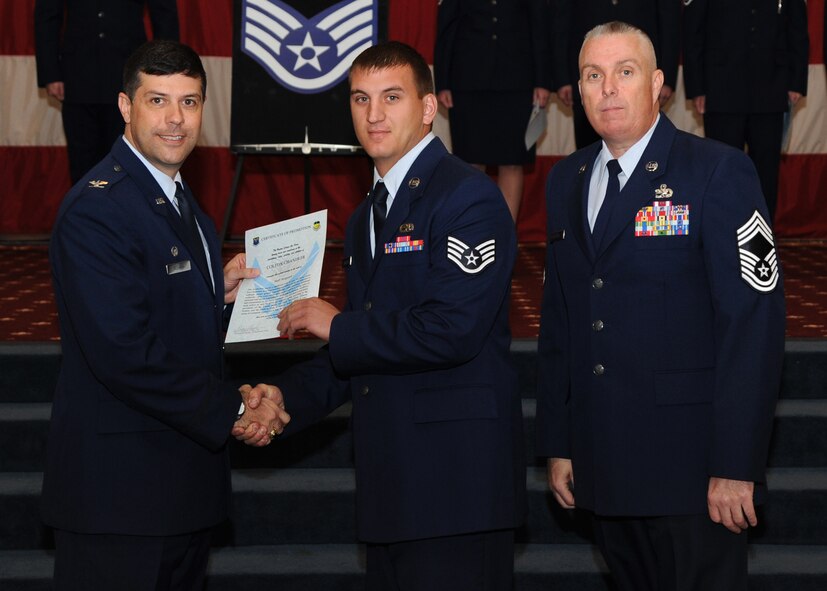Staff Sgt. Colton Chandler, 2nd Maintenance Squadron, receives a certificate of promotion from Col. Andrew Gebara, 2nd Bomb Wing commander, and Chief Master Sgt. Beau Markin, 2nd Maintenance Group, during the November Wing Promotion Ceremony on Barksdale Air Force Base, La., Nov. 27, 2013. (U.S. Air Force photo/Senior Airman Joseph A. Pagán Jr.)