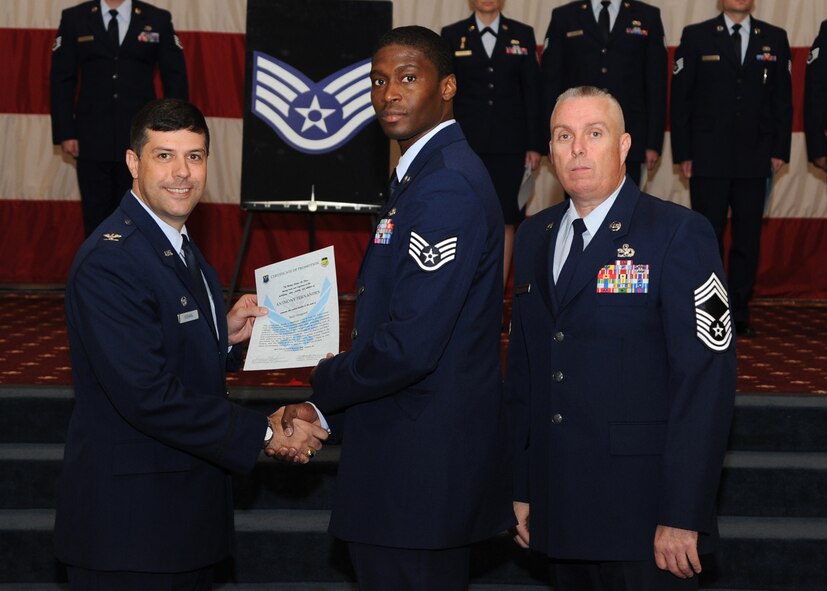 Staff Sgt. Anthony Fernandes, 2nd Logistics Readiness Squadron, receives a certificate of promotion from Col. Andrew Gebara, 2nd Bomb Wing commander, and Chief Master Sgt. Beau Markin, 2nd Maintenance Group, during the November Wing Promotion Ceremony on Barksdale Air Force Base, La., Nov. 27, 2013. (U.S. Air Force photo/Senior Airman Joseph A. Pagán Jr.)
