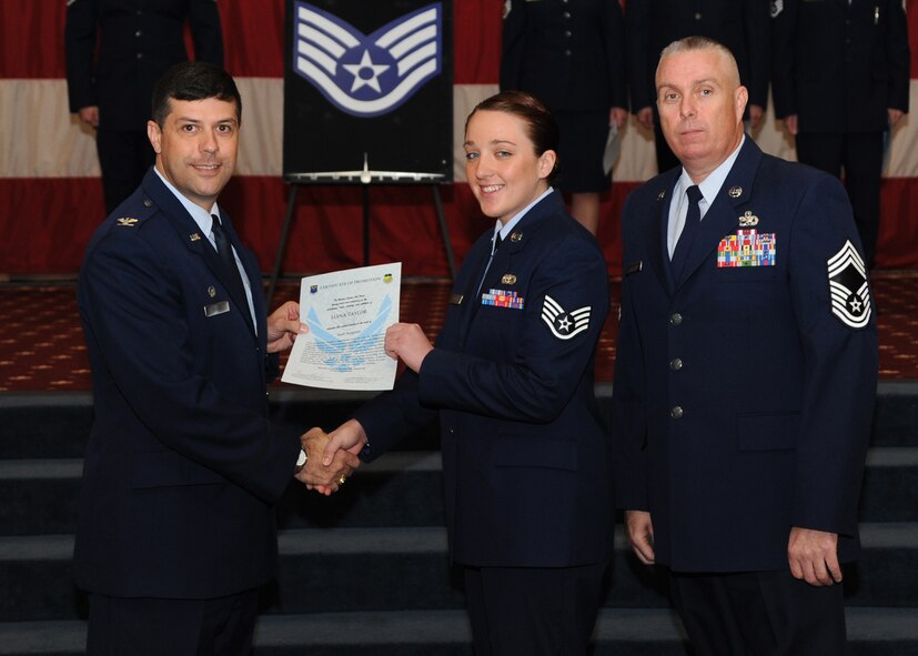 Staff Sgt. Liana Taylor, 2nd Force Support Squadron, receives a certificate of promotion from Col. Andrew Gebara, 2nd Bomb Wing commander, and Chief Master Sgt. Beau Markin, 2nd Maintenance Group, during the November Wing Promotion Ceremony on Barksdale Air Force Base, La., Nov. 27, 2013. (U.S. Air Force photo/Senior Airman Joseph A. Pagán Jr.)