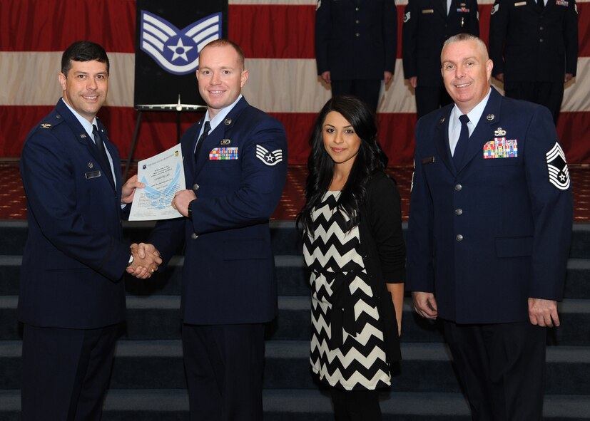 Staff Sgt. James Blake, 2nd Civil Engineer Squadron, receives a certificate of promotion from Col. Andrew Gebara, 2nd Bomb Wing commander, and Chief Master Sgt. Beau Markin, 2nd Maintenance Group, during the November Wing Promotion Ceremony on Barksdale Air Force Base, La., O Nov. 27, 2013. (U.S. Air Force photo/Senior Airman Joseph A. Pagán Jr.)