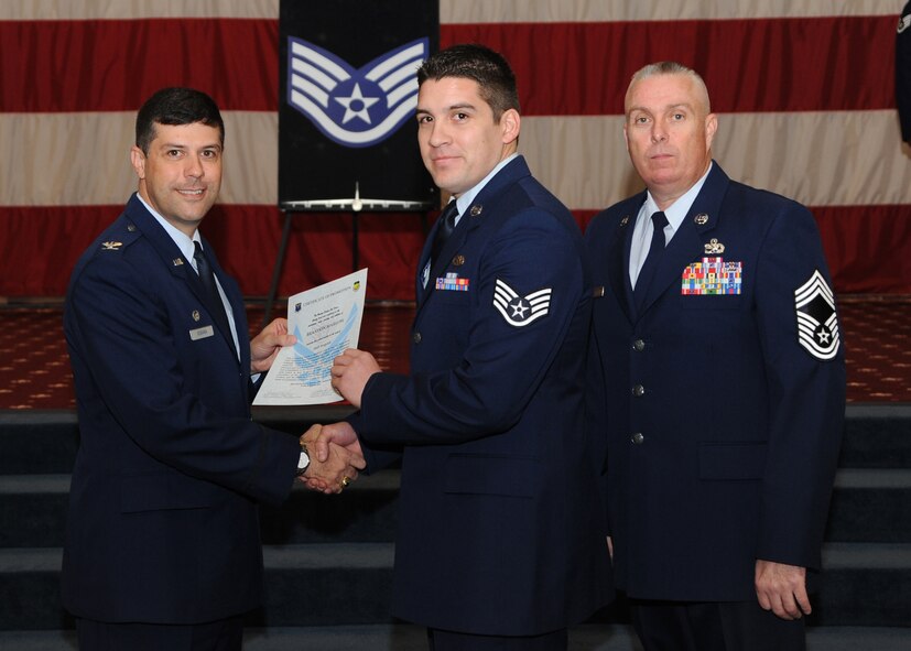 Staff Sgt. Brandon Marlow, 2nd Aircraft Maintenance Squadron, receives a certificate of promotion from Col. Andrew Gebara, 2nd Bomb Wing commander, and Chief Master Sgt. Beau Markin, 2nd Maintenance Group, during the November Wing Promotion Ceremony on Barksdale Air Force Base, La., Nov. 27, 2013. (U.S. Air Force photo/Senior Airman Joseph A. Pagán Jr.)