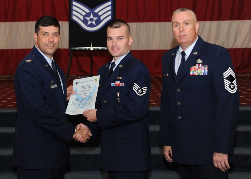 Staff Sgt. Glenn Cihak III, 2nd Aircraft Maintenance Squadron, receives a certificate of promotion from Col. Andrew Gebara, 2nd Bomb Wing commander, and Chief Master Sgt. Beau Markin, 2nd Maintenance Group, during the November Wing Promotion Ceremony on Barksdale Air Force Base, La., Nov. 27, 2013. (U.S. Air Force photo/Senior Airman Joseph A. Pagán Jr.)