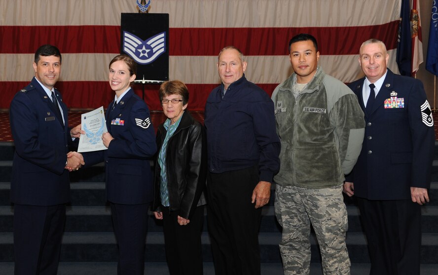 Staff Sgt. Heather Casel, 2nd Aerospace Medicine Squadron, receives a certificate of promotion from Col. Andrew Gebara, 2nd Bomb Wing commander, and Chief Master Sgt. Beau Markin, 2nd Maintenance Group, during the November Wing Promotion Ceremony on Barksdale Air Force Base, La., Nov. 27, 2013. (U.S. Air Force photo/Senior Airman Joseph A. Pagán Jr.)