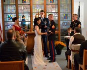 Westover's new chaplain, (Capt) Chaplain Matthew Zimmerman presides over the ceremony of SSgt. Kelly Galloway, 439th Airlift Wing, and Sgt. Terrence Goonan, Marine Air Support Squadron-6, inside the base Chapel Oct. 24, 2013. (U.S. Air Force photo/William C. Pope)