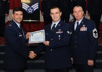 Senior Airman David Duberger II, 2nd Munitions Squadron, receives a certificate of promotion from Col. Andrew Gebara, 2nd Bomb Wing commander, and Chief Master Sgt. Beau Markin, 2nd Maintenance Group, during the November Wing Promotion Ceremony on Barksdale Air Force Base, La., Nov. 27, 2013. (U.S. Air Force photo/Senior Airman Joseph A. Pagán Jr.)