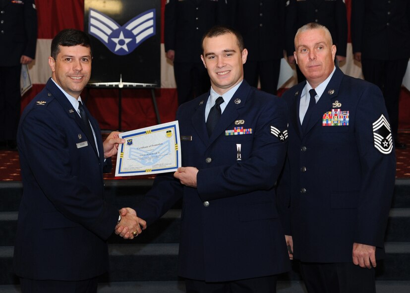 Senior Airman David Duberger II, 2nd Munitions Squadron, receives a certificate of promotion from Col. Andrew Gebara, 2nd Bomb Wing commander, and Chief Master Sgt. Beau Markin, 2nd Maintenance Group, during the November Wing Promotion Ceremony on Barksdale Air Force Base, La., Nov. 27, 2013. (U.S. Air Force photo/Senior Airman Joseph A. Pagán Jr.)