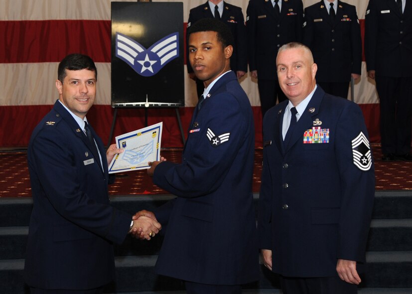Senior Airman Kiron St. Laurent, 2nd Maintenance Squadron, receives a certificate of promotion from Col. Andrew Gebara, 2nd Bomb Wing commander, and Chief Master Sgt. Beau Markin, 2nd Maintenance Group, during the November Wing Promotion Ceremony on Barksdale Air Force Base, La., Nov. 27, 2013. (U.S. Air Force photo/Senior Airman Joseph A. Pagán Jr.)