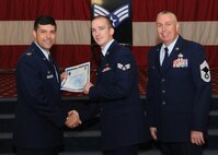 Senior Airman Anthony Hopper, 2nd? Maintenance Squadron, receives a certificate of promotion from Col. Andrew Gebara, 2nd Bomb Wing commander, and Chief Master Sgt. Beau Markin, 2nd Maintenance Group, during the November Wing Promotion Ceremony on Barksdale Air Force Base, La., Nov. 27, 2013. (U.S. Air Force photo/Senior Airman Joseph A. Pagán Jr.)