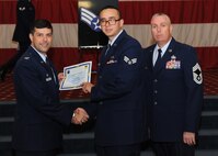 Senior Airman Scott Hooper, 2nd Maintenance Squadron, receives a certificate of promotion from Col. Andrew Gebara, 2nd Bomb Wing commander, and Chief Master Sgt. Beau Markin, 2nd Maintenance Group, during the November Wing Promotion Ceremony on Barksdale Air Force Base, La., Nov. 27, 2013. (U.S. Air Force photo/Senior Airman Joseph A. Pagán Jr.)
