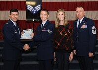 Senior Airman Shane Rosenberry, 2nd Communications Squadron, receives a certificate of promotion from Col. Andrew Gebara, 2nd Bomb Wing commander, and Chief Master Sgt. Beau Markin, 2nd Maintenance Group, during the November Wing Promotion Ceremony on Barksdale Air Force Base, La., Nov. 27, 2013. (U.S. Air Force photo/Senior Airman Joseph A. Pagán Jr.)