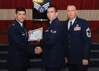 Senior Airman Corry Westbrook, 2nd Aircraft Maintenance Squadron, receives a certificate of promotion from Col. Andrew Gebara, 2nd Bomb Wing commander, and Chief Master Sgt. Beau Markin, 2nd Maintenance Group, during the November Wing Promotion Ceremony on Barksdale Air Force Base, La., Nov. 27, 2013. (U.S. Air Force photo/Senior Airman Joseph A. Pagán Jr.)