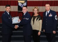 Senior Airman Tyler Berthelot, 2nd Aircraft Maintenance Squadron, receives a certificate of promotion from Col. Andrew Gebara, 2nd Bomb Wing commander, and Chief Master Sgt. Beau Markin, 2nd Maintenance Group, during the November Wing Promotion Ceremony on Barksdale Air Force Base, La., Nov. 27, 2013. (U.S. Air Force photo/Senior Airman Joseph A. Pagán Jr.)