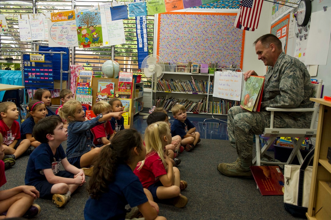 Col. Johnny Roscoe, 15th Wing commander, reads a favorite childhood book, The Big Hungry Bear, to a kindergarten class at Hickam Elementary School on Joint Base Pearl Harbor-Hickam, Hawaii, Dec. 2, 2013. Roscoe’s visit to the school was part of the weekly Rockin’ Reader program which invites volunteers to the school for story time with the children. (U.S. Air Force photo/Staff Sgt. Terri Paden)