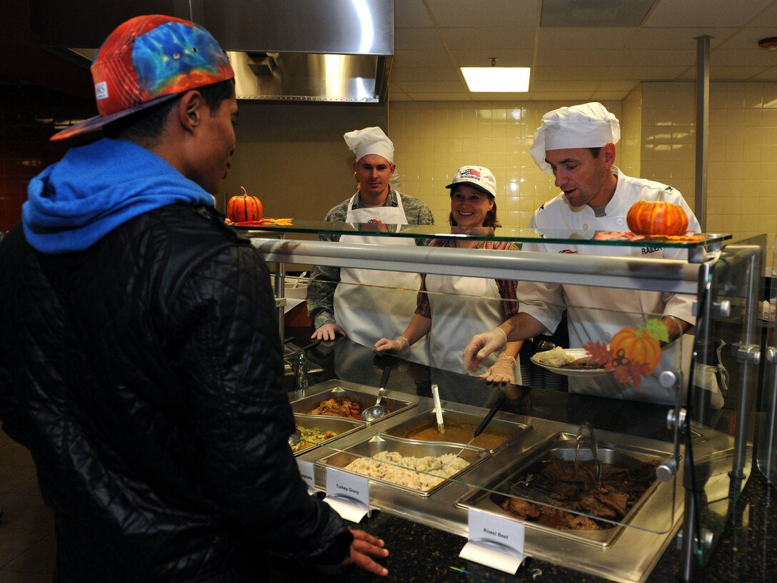 Col. Kevin Kennedy, 28th Bomb Wing commander, teamed up with base leaders to serve thanksgiving lunch to Airmen in the Raider Café at Ellsworth Air Force Base, S.D., Nov. 28, 2013, as a small way of showing their appreciation for all of their hard work and dedication.  Airmen were welcomed and served a traditional Thanksgiving by several senior base leaders. (U.S. Air Force photo by Airman 1st Class Rebecca Imwalle/Released)