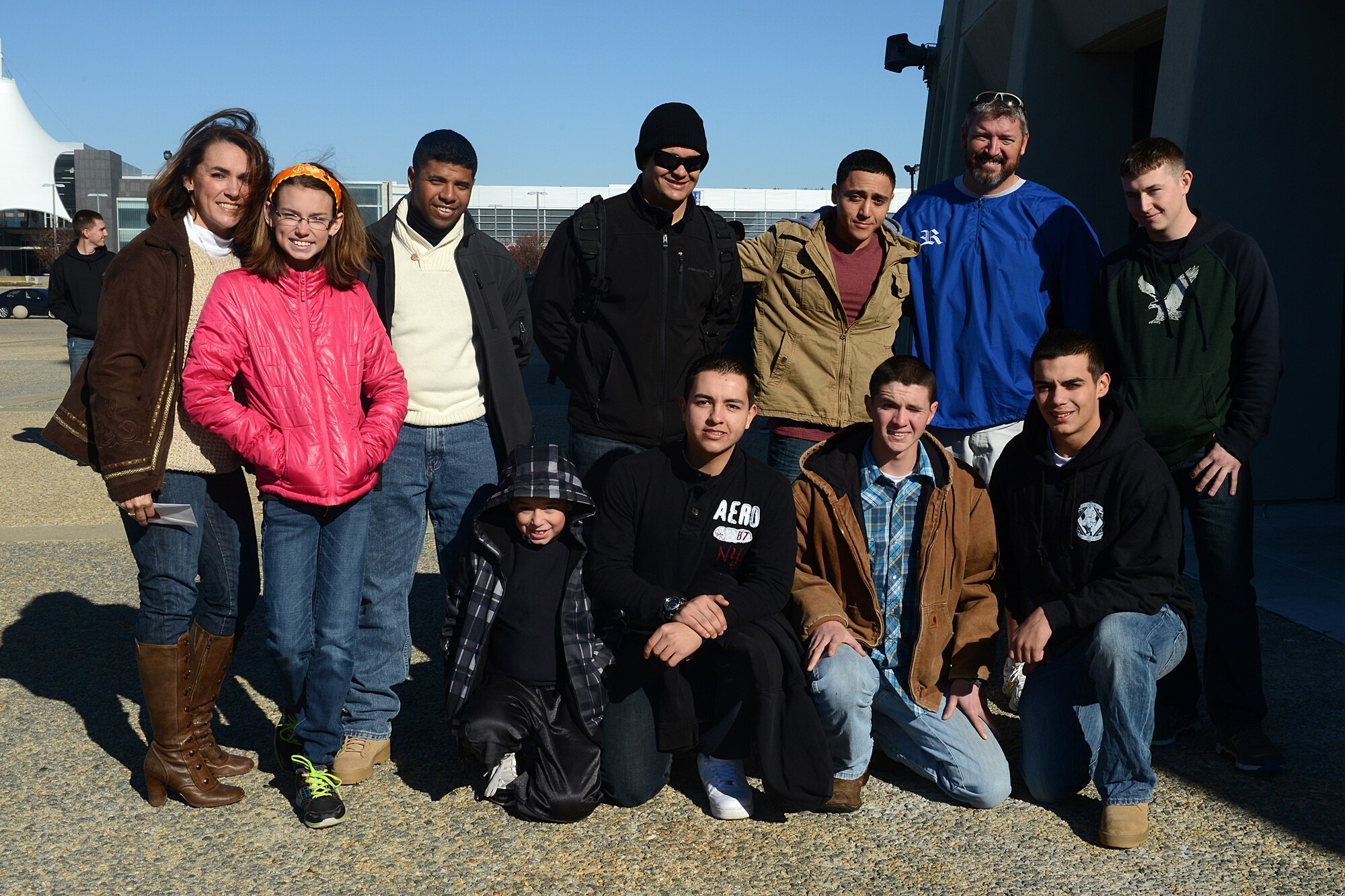 April Girffin, a local community member, and her family take a photo with U.S. Army Advanced Individual Training Soldiers from Fort Eustis during the USO of Hampton Roads and Central Virginia’s “Adopt-A-Service Person” program at the Hampton Coliseum in Hampton, Va., Nov. 28, 2013. The Griffins “adopted” seven Soldiers, opening their home for Thanksgiving dinner to Service members who were unable to make it home for the holiday. (U.S. Air Force photo by Airman 1st Class Kimberly Nagle/Released)