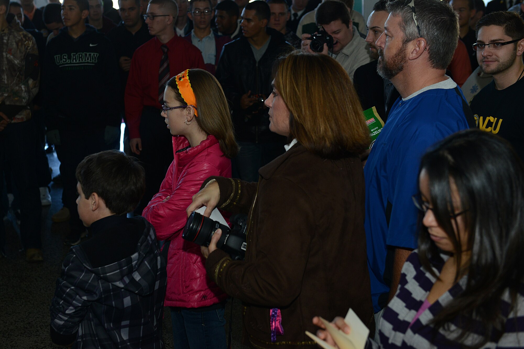 April Griffin, a Hampton Roads community member, and her family wait at the Hampton Coliseum to gather their “adopted” U.S. Army Soldiers for the “Adopt-A-Service Person” program in Hampton, Va., Nov. 28, 2013. Griffin and her family saw this opportunity as a way to give back to the community. (U.S. Air Force photo by Airman 1st Class Kimberly Nagle/Released)