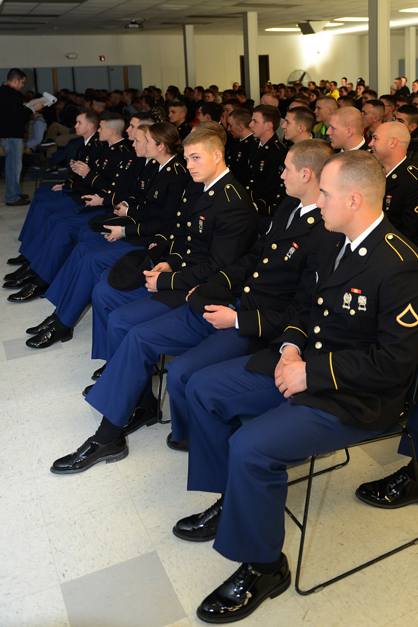 U.S. Army Advanced Individual Training Soldiers from the 1st Battalion, 222nd Aviation Regiment at Fort Eustis, attended an “Adopt-A-Service Person” program briefing before heading to the Hampton Coliseum in Hampton, Va., Nov. 28, 2013. The Soldiers were “adopted” out to local families for Thanksgiving dinner because they were unable to make it home for the holiday. (U.S. Air Force photo by Airman 1st Class Kimberly Nagle/Released)