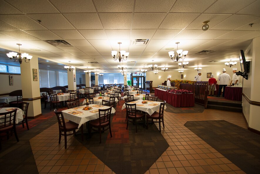 Airmen and family members prepare the dining area as they wait for the first guest at Moody Air Force Base, Ga., Nov. 28, 2013. Each year, commanders, chiefs and first sergeants volunteer to serve a Thanksgiving meal to Moody’s Airmen. (U.S. Air Force photo by Airman 1st Class Ryan Callaghan/Released)
