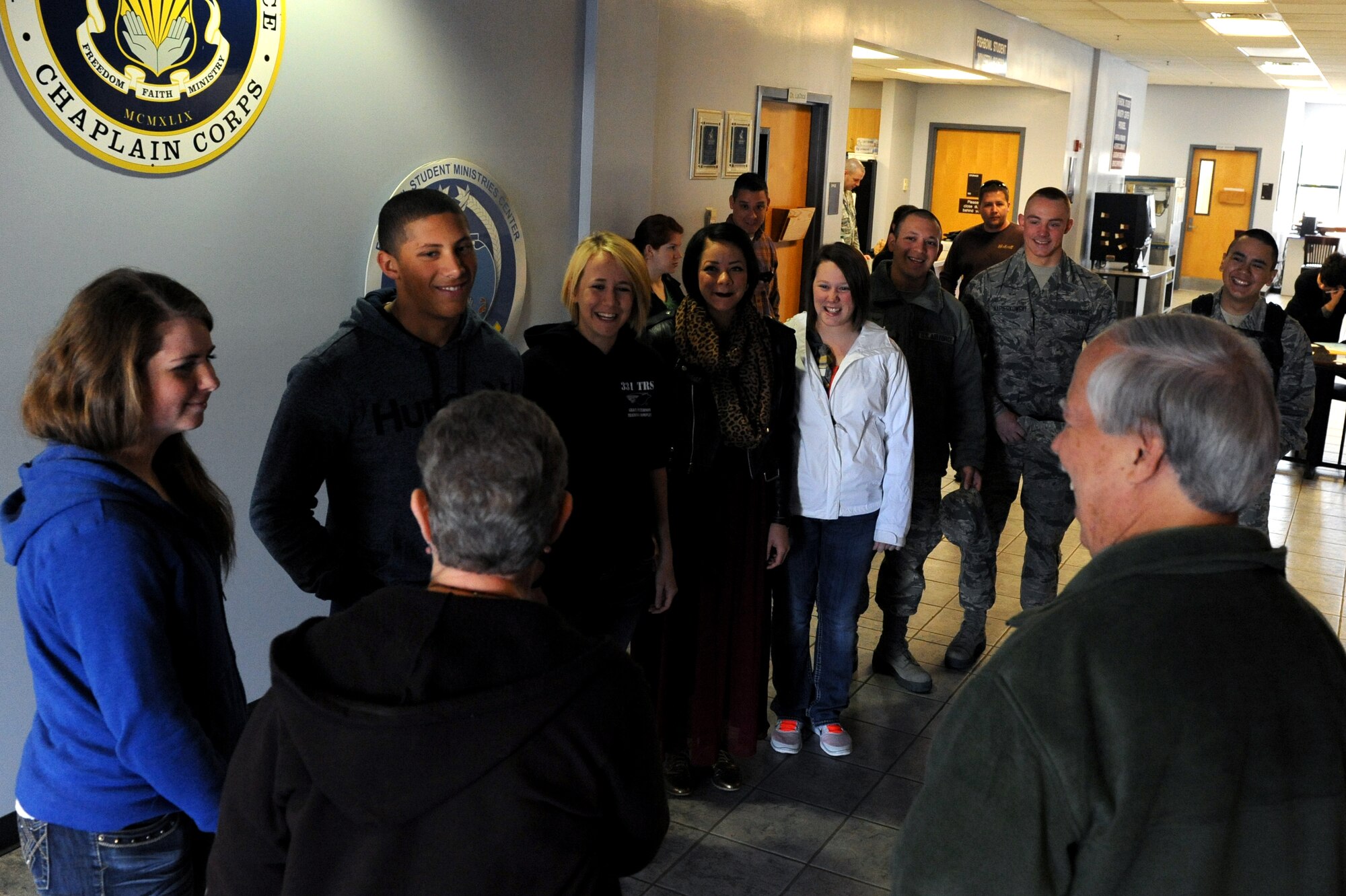 Irene McIntosh and Ed Cake greet the 81st Training Wing Airmen they are sponsoring for the “Home Away From Home” program, Keesler Air Force Base, Miss., Nov. 28, 2013. The “Home Away From Home” is a program sponsored by the 81st Training Wing Chapel that allows Team Keesler and local residents to sponsor non-prior service Airmen who couldn’t make it home for Thanksgiving to enjoy a home cooked meal. This is Irene’s fifth year participating in the program.