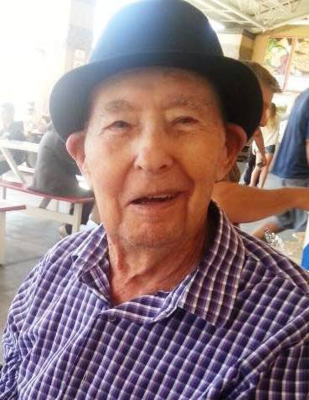 William "Bill" Evans Sr., a WWII veteran, enjoys Veteran's Day 2013 in the community where he was treated to a free haircut and a hot dog. (U.S. Air Force photo/Linda Welz)