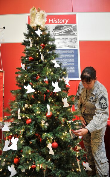 U.S. Air Force Chief Master Sgt. Suzanne Talbert, 20th Fighter Wing interim command chief, looks over angels on the angel tree at Shaw Air Force Base, S.C., Nov. 25, 2013. The angel tree program serves as an opportunity for Team Shaw members to sponsor a child, and receive the joy that comes from giving to those who are in need.  (U.S. Air Force photo by Airman 1st Class Jonathan Bass/Released)