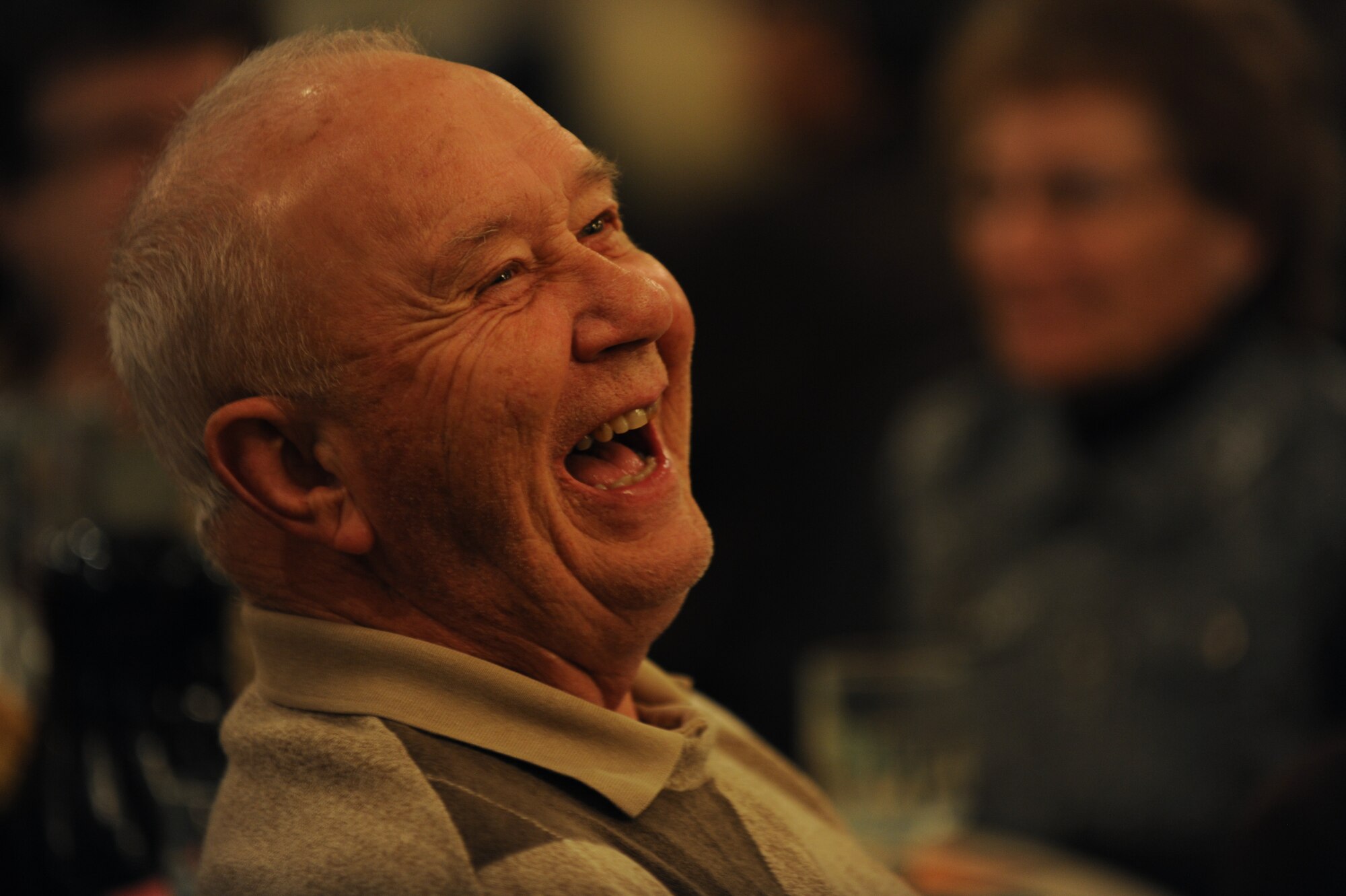 A senior citizen from the Minot community laughs at a joke told by the Bingo game host during the Day of Love event at Minot Air Force Base, N.D., Nov. 28, 2013. In addition serving food, Airmen hosted a game of Bingo for guests, with prizes awarded to the winners. (U.S. Air Force photos/Senior Airman Jose L. Hernandez)