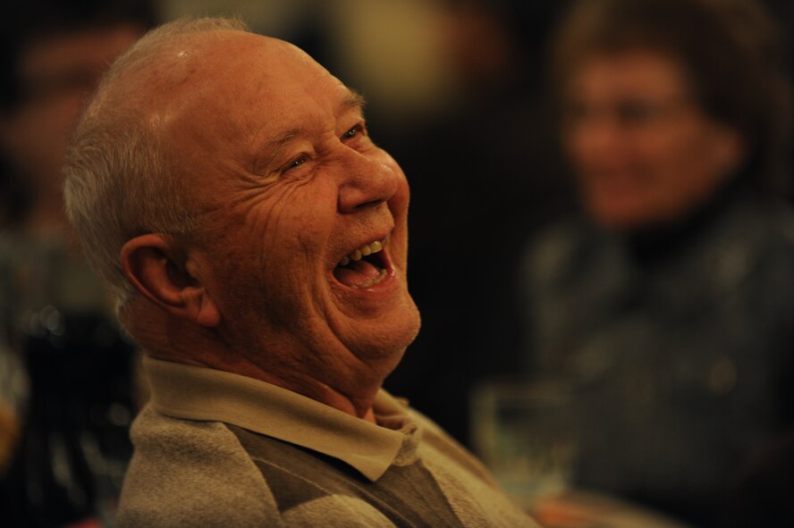 A senior citizen from the Minot community laughs at a joke told by the Bingo game host during the Day of Love event at Minot Air Force Base, N.D., Nov. 28, 2013. In addition serving food, Airmen hosted a game of Bingo for guests, with prizes awarded to the winners. (U.S. Air Force photos/Senior Airman Jose L. Hernandez)