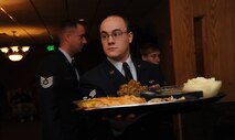 Senior Airman Christopher Francis, 5th Civil Engineer Squadron structures journeyman, prepares to serve a meal course to guests during the 44th annual Day of Love event at Minot Air Force Base, N.D., Nov. 28. The Thanksgiving Day event is a tradition where Airmen show their appreciation to the elderly of the Minot community by serving them lunch meals. (U.S. Air Force photo/Senior Airman Jose L. Hernandez)