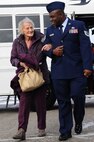 Tech. Sgt. Reginald Athouriste, 5th Civil Engineer Squadron, escorts a senior citizen from the Minot community into the Jimmy Doolittle Center as part of the 44th annual Day of Love event at Minot Air Force Base, N.D., Nov. 28. Team Minot Airmen volunteer to help serve food and spend time with the guests each year during Thanksgiving Day to show their appreciation to the local community. (U.S. Air Force photo/Senior Airman Jose L. Hernandez)