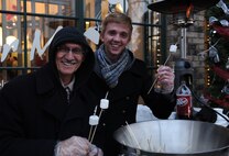 Small shops and businesses throughout downtown Minot decorated their doors with holly for the annual tree lighting Nov. 30, 2013, in downtown Minot. With fire pits set up along street corners, some businesses handed out marshmallows and chocolate for s’mores. (U.S. Air Force photo/Airman 1st Class Lauren Pitts)