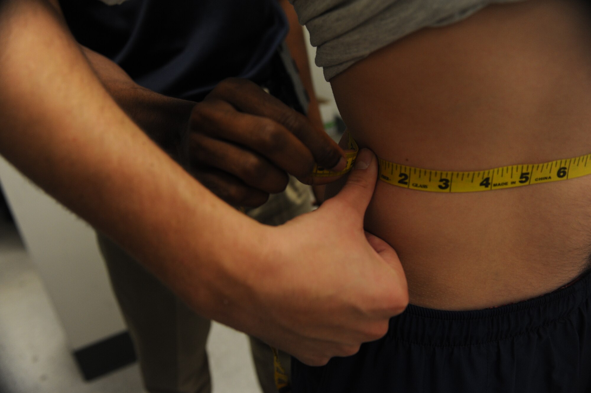 An Airman’s waist is measured during a physical fitness test at Minot Air Force Base, N.D., Oct. 21. Changes to the Air Force fitness assessment now allow a member to be tested on body mass index in the event that they fail the waist measurement section and still pass all other components of the test. (U.S. Air Force photo/Senior Airman Stephanie Sauberan)