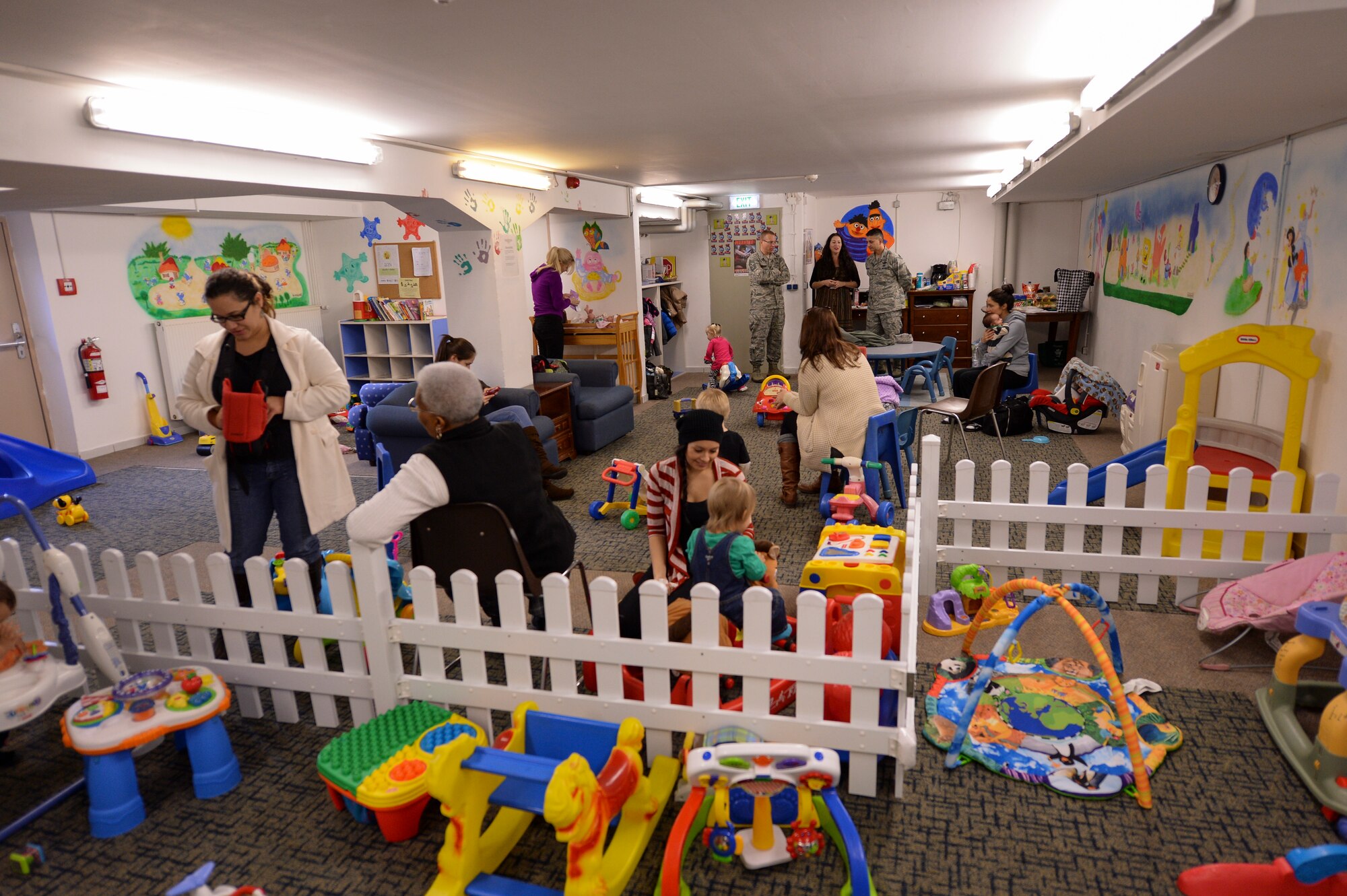 SPANGDAHLEM AIR BASE, Germany-- Parents take care of their children during a Family Advocacy Play Group meeting Dec. 3, 2013. More than 30 families attend weekly meetings. (U.S. Air Force photo by Senior Airman Rusty Frank/Released)