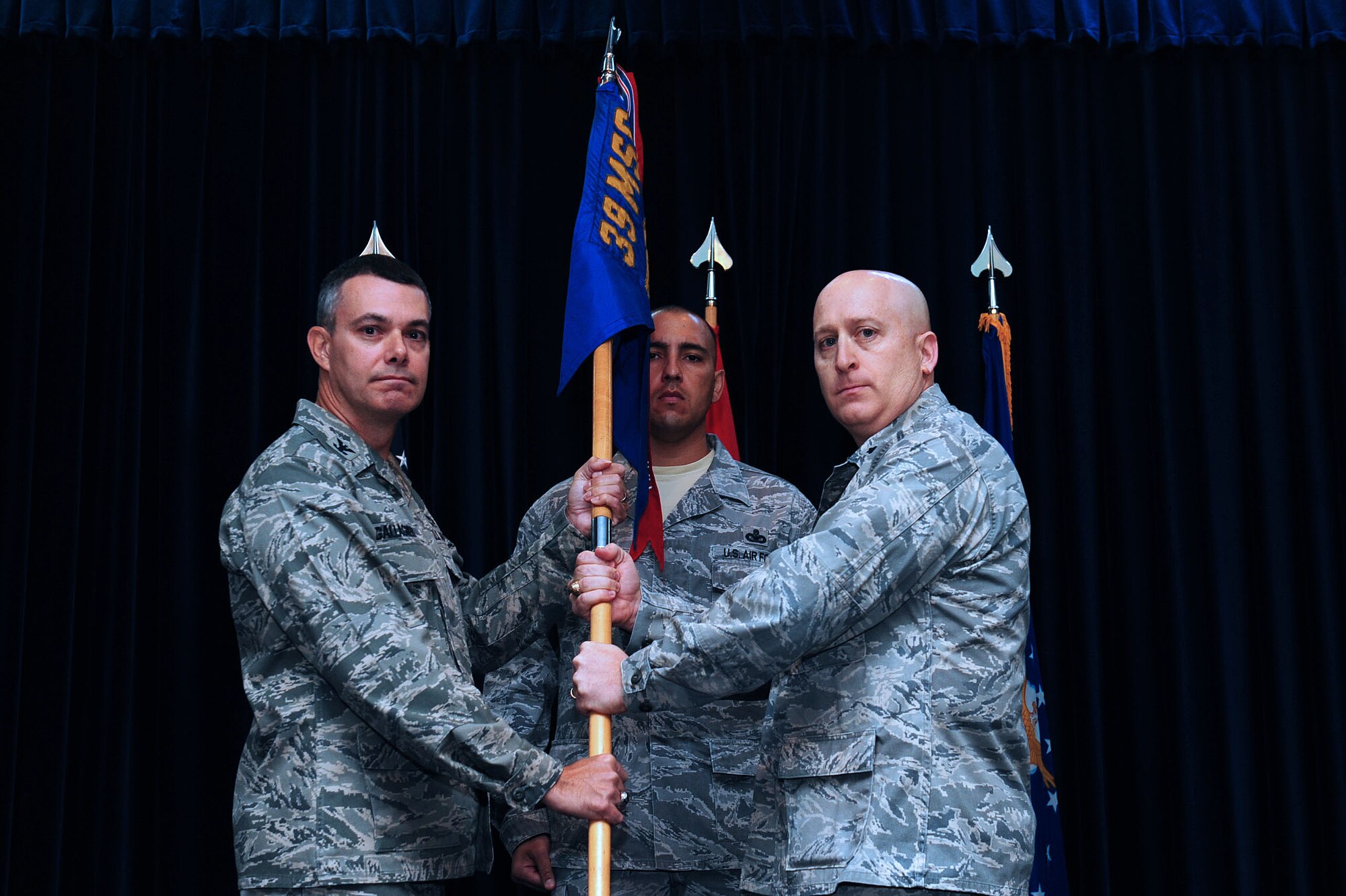 Col. Sean Gallagher, 39th Mission Support Group commander, passes the 39th Security Forces Squadron guidon to Lt. Col. Lee Curoe, 39th Security Forces Squadron commander, during the 39th SFS assumption of command ceremony Dec. 2, 2013, at Incirlik Air Base, Turkey. An assumption of command ceremony is a tradition that represents a formal acceptance of authority and responsibility to the incoming commander. (U.S. Air Force photo by Airman 1st Class Nicole Sikorski/Released) 
