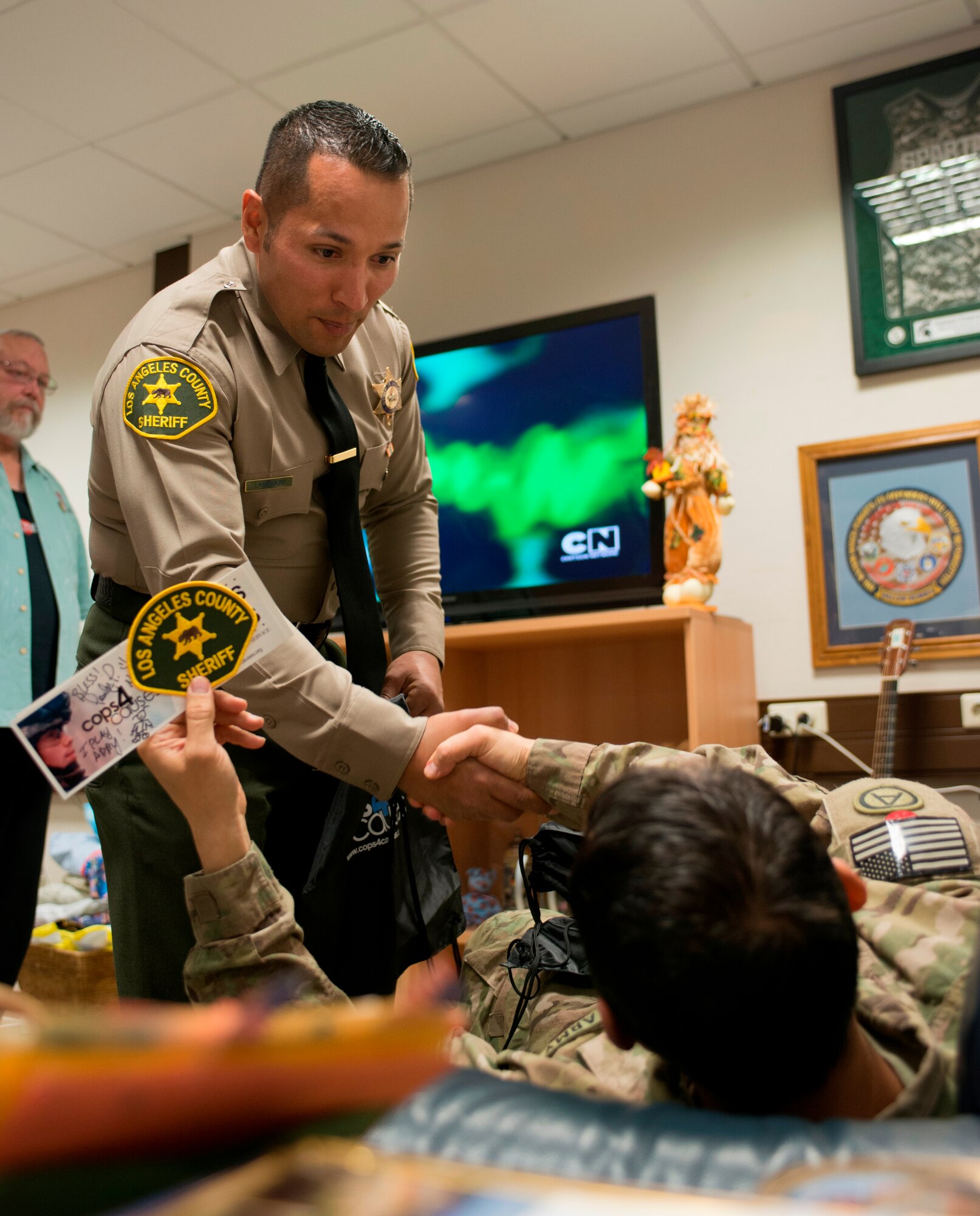 Christopher Landavazo, Cops 4 Causes president, shakes hands with a wounded
military member, Nov. 24, 2013, Ramstein Air Base, Germany. Along with visiting
wounded warriors, the Cops 4 Causes toured various facilities around the KMC. (U.S.
Air Force photo/Senior Airman Jonathan Stefanko)