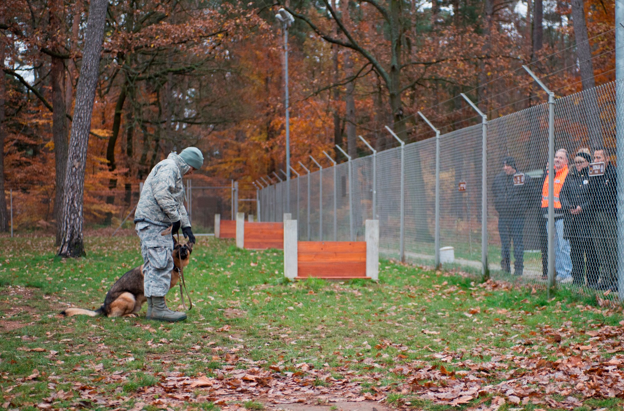 Members of the Cops 4 Causes organization watch a military working dog demonstration at the 86th Security Forces Squadron MWD facility, Nov. 22, 2013, Ramstein Air Base, Germany. Cops 4 Causes arrived to Ramstein to deliver 700 care packages to troops stationed here as well as visit various facilities around the KMC. (U.S. Air Force photo/Senior Airman Jonathan Stefanko)