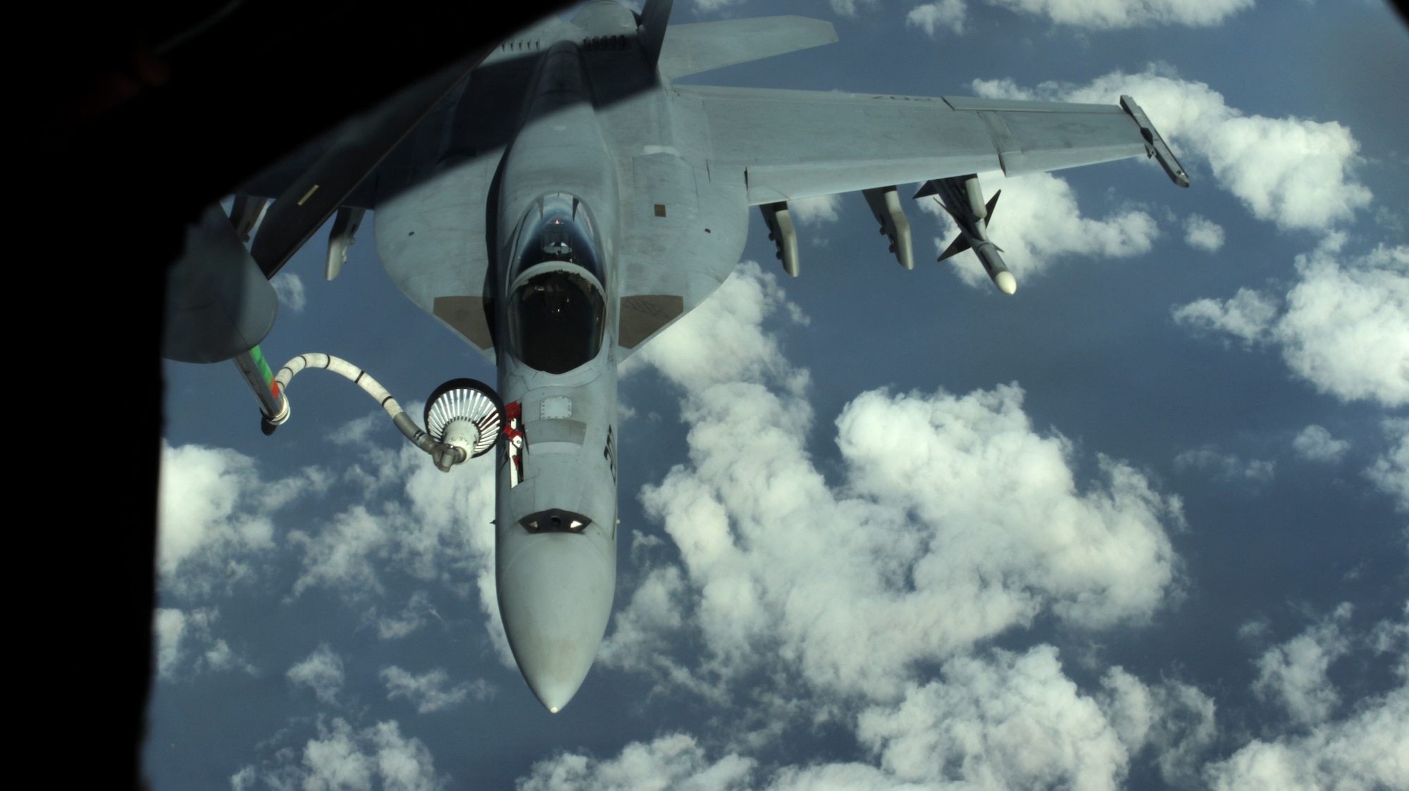 A U.S. Navy F/A-18 Super Hornet is refueled by a U.S. Air Force KC-135 Stratotanker from Kadena Air Base, Japan, Nov. 26, 2013. The 909th Aerial Refueling Squadron is one of only two aerial refueling squadrons in the Pacific region, which makes frequent joint training missions a necessity in retaining their skills. (U.S. Air Force photo by Airman 1st Class Todd Holly)