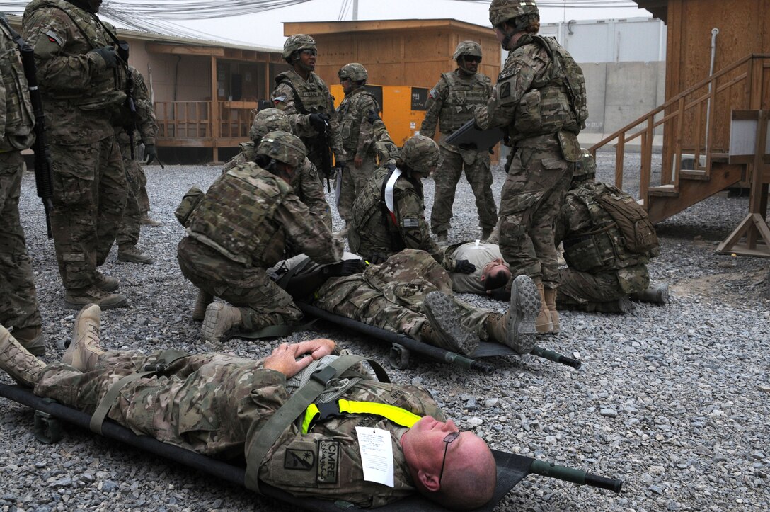 U.S. soldiers apply their medical training skills to simulated casualties during a mass casualty exercise on Kandahar Airfield, Afghanistan, Nov. 22, 2013.