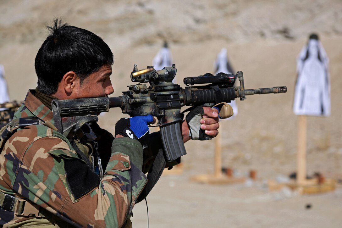 An Afghan Army Special Forces Soldier Fires His Weapon At A Target