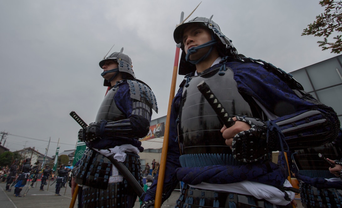 Sgt. Justin Pack, operations chief with the station Public Affairs Office, and Cpl. Javier King personnel administrator with station installation personnel administration center, march around a plaza during the Kuragake Castle Festival, Nov. 17 2013. Pack and King were two of five Marines from Marine Corps Air Station Iwakuni, Japan, to participate in this event, which celebrated a battle that occurred during the 16th century in Kuga, Iwakuni City. 