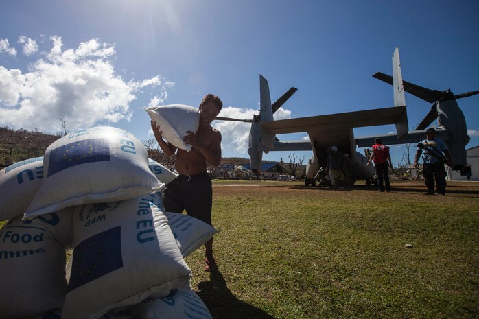 A Filipino carries a 110 lbs. bag of rice from the back of an MV-22 Osprey with Marine Medium Tiltrotor Squadron-265, 31st Marine Expeditionary Unit (MEU), during a supply drop-off at a village here, Nov. 25. The combined Philippine and international effort delivered more than 79,000 lbs. of rice and high-energy biscuits to eight island villages. The 31st MEU, deployed with 3D Marine Expeditionary Brigade, in support of Joint Task Force 505, is currently supporting the government of the Philippines during Operation Damayan by assisting with disaster relief efforts in areas affected by Super Typhoon Haiyan/Yolanda. 