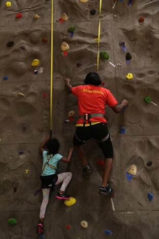 Marines and their families gather at the rock wall inside the AS-4400 gym aboard Marine Corps Air Station New River, as part of the Family Rock Wall Climbing Night, Nov. 22. The Family Rock Wall Climbing Night is hosted every Friday evening from 6-9 p.m. 