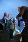 A selected family flips a switch to light an 18-foot Christmas tree during a tree lighting ceremony at the Marine Corps Air Station New River Officers Club, Dec. 1.
