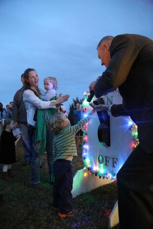 A selected family flips a switch to light an 18-foot Christmas tree during a tree lighting ceremony at the Marine Corps Air Station New River Officers Club, Dec. 1.

